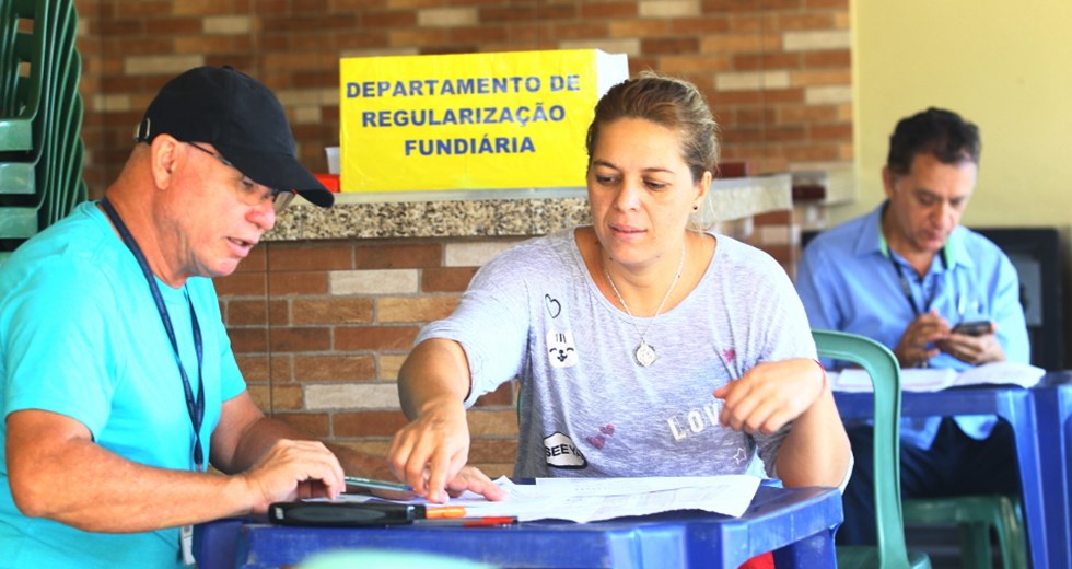 A moradora Roseli de Sá Cardoso é atendida por servidor da Prefeitura